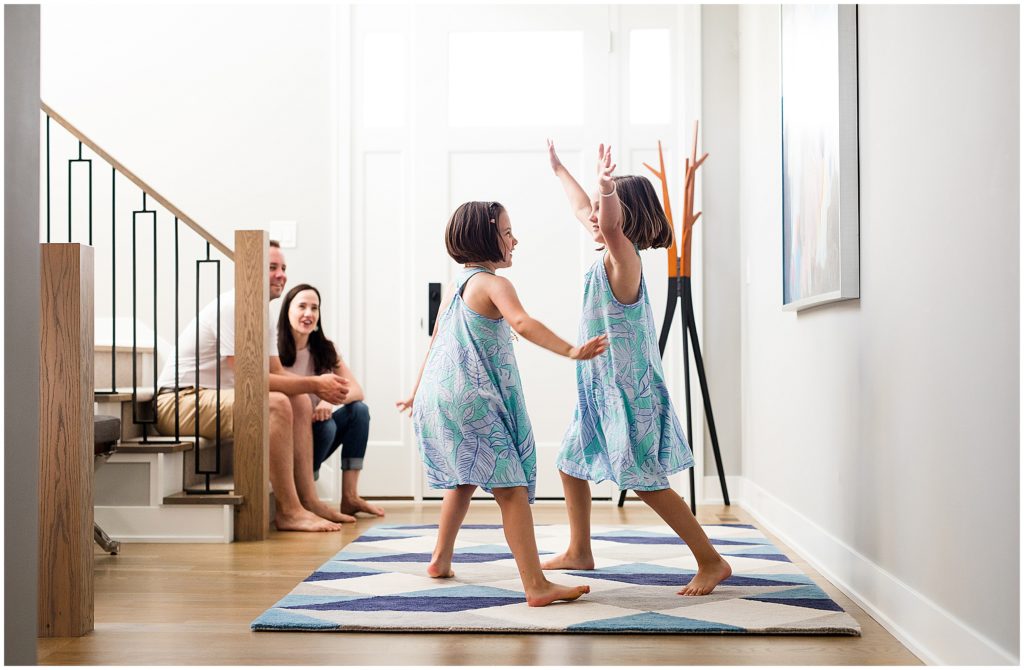 Sisters dancing in their home in an at-home family session in Edina, MN