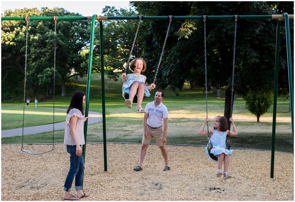 Family at park on swings for an at-home family session in Edina, MN