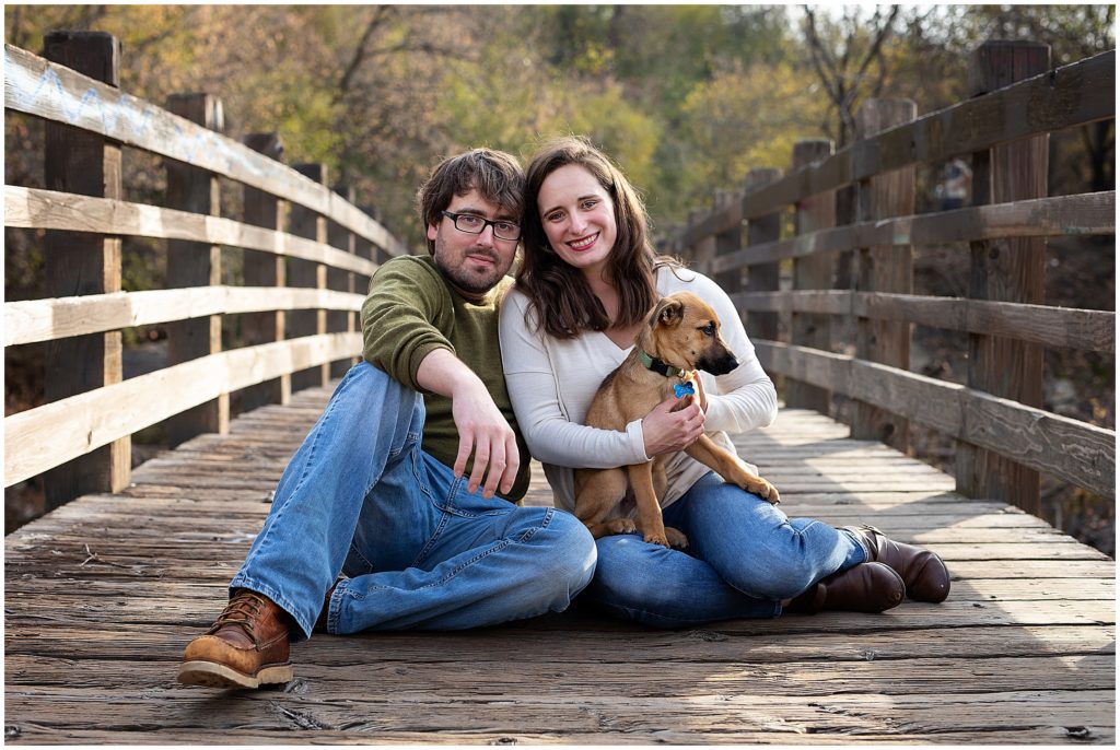 Couple with puppy on a bridge during a Stone Arch Bridge Family Photography
