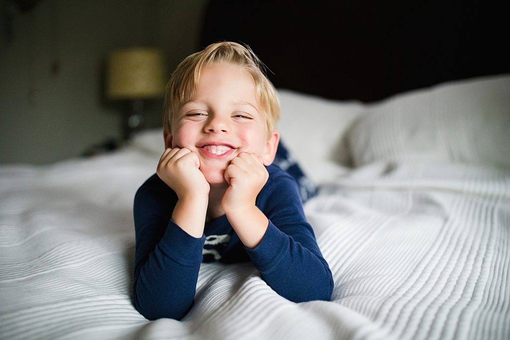 Little boy smiling on bed