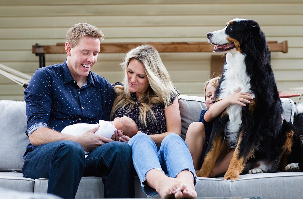 Family holding baby with dog