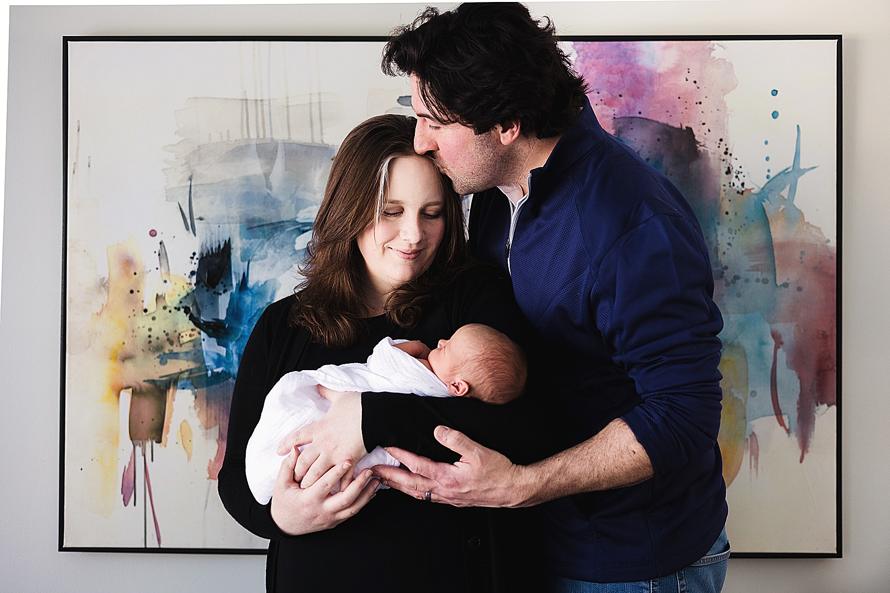 Edina Newborn Photographer - Parents with Baby in front of art
