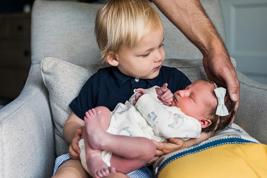 Edina Newborn Photos with big brother holding little sister.