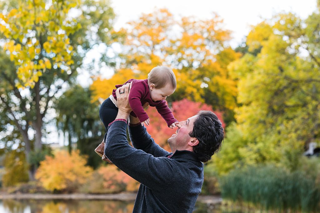 Baby held up by dad in fall