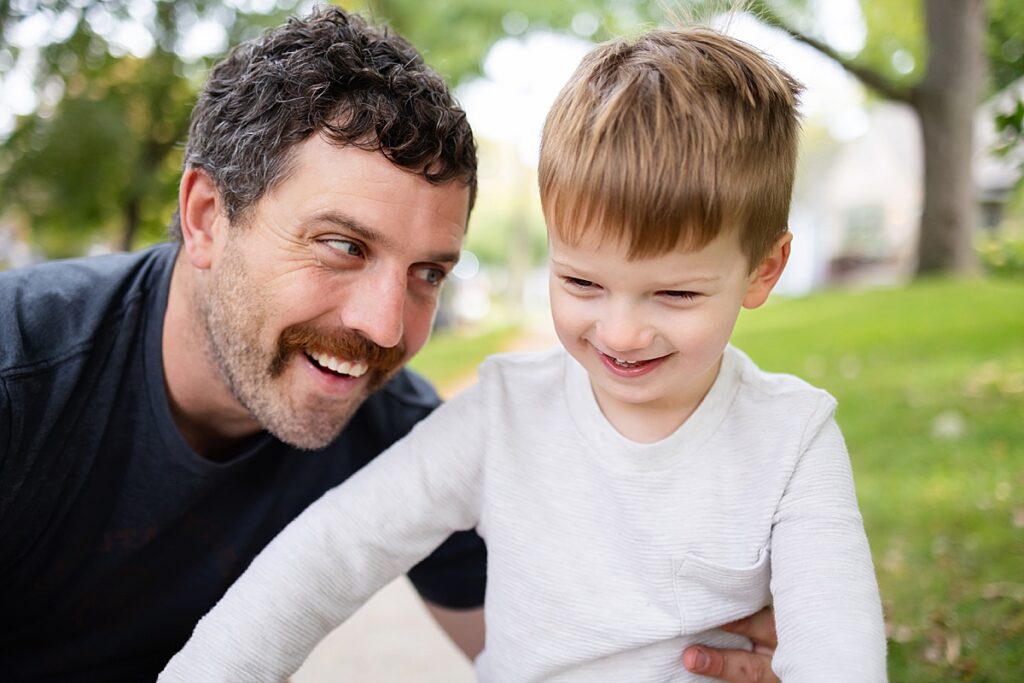 Dad and son smiling during a Minneapolis Family Photo session