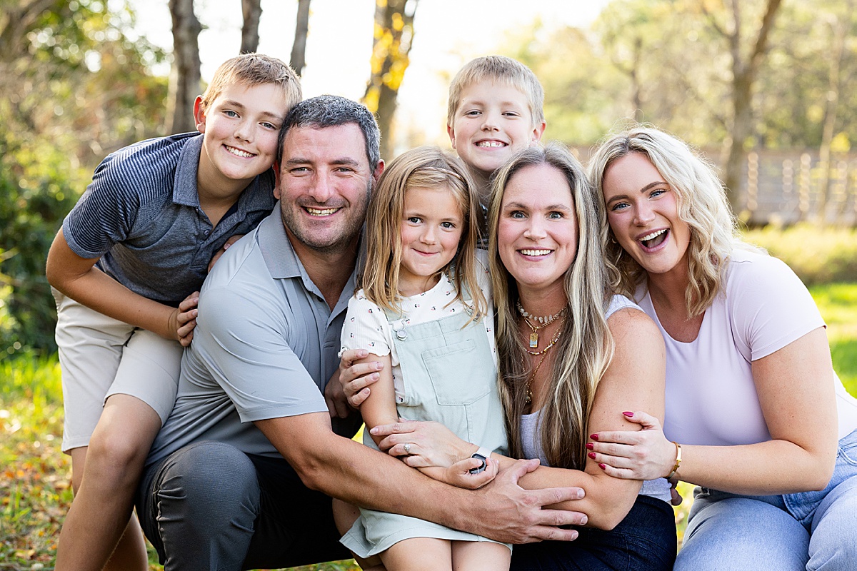 a family of six pose for their family photos at Richardson Nature Center