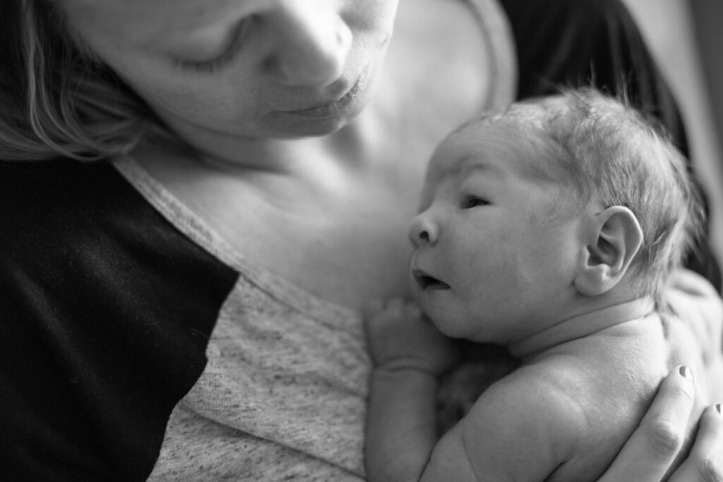 black and white photo of a mom and new brand new baby -Choosing a Fresh 48 Photographer in Minnesota
